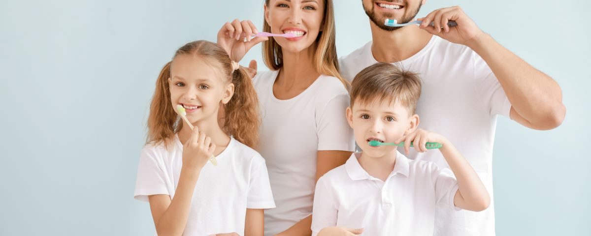 Family practicing good oral health together.