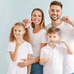 Family practicing good oral health together.