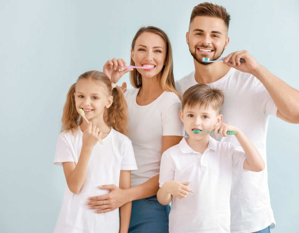 Family practicing good oral health together.