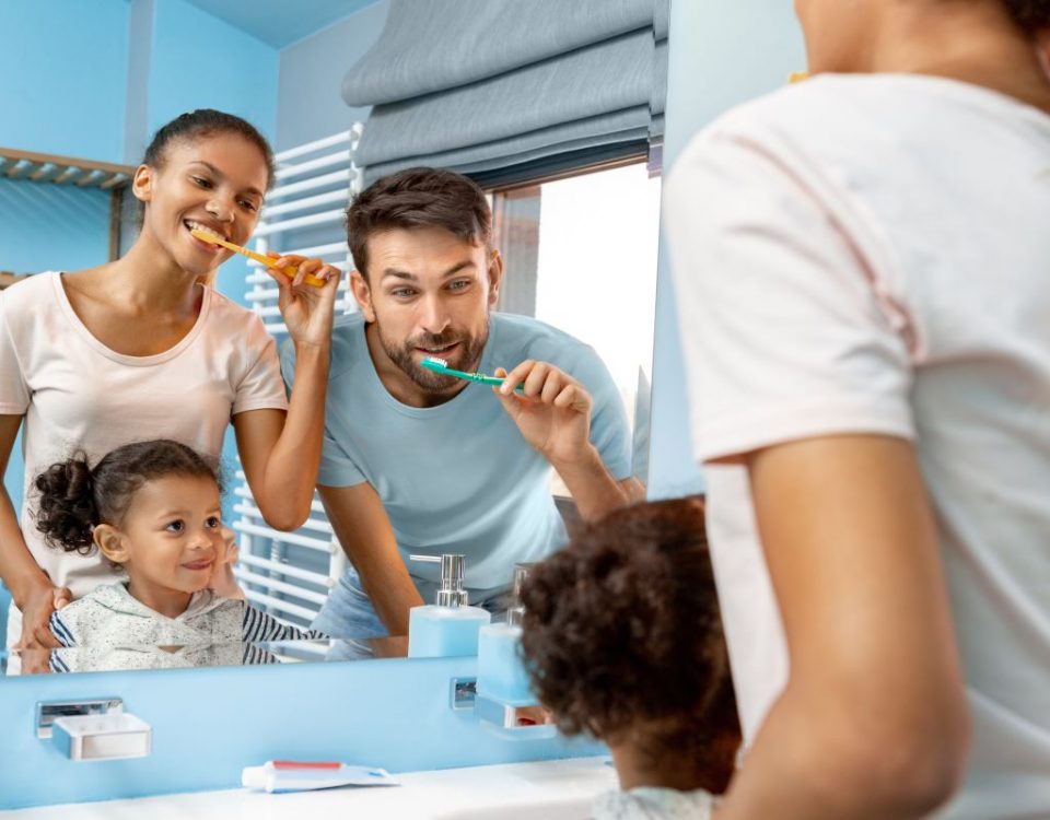 Family practicing their oral health together.