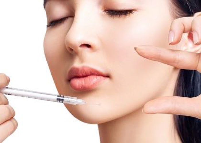 Person receiving facial injection treatment