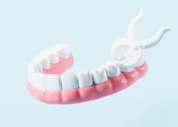 Dental model with tool on blue background.