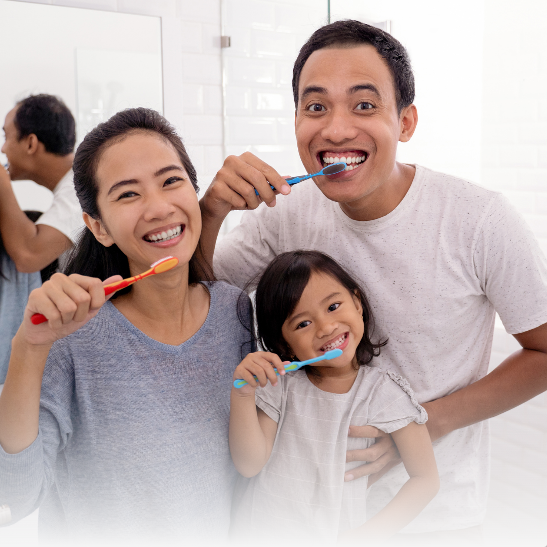 Family brushing teeth together in bathroom